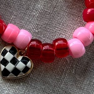 Pony bead red and pink bracelet  with black and white checkered heart
